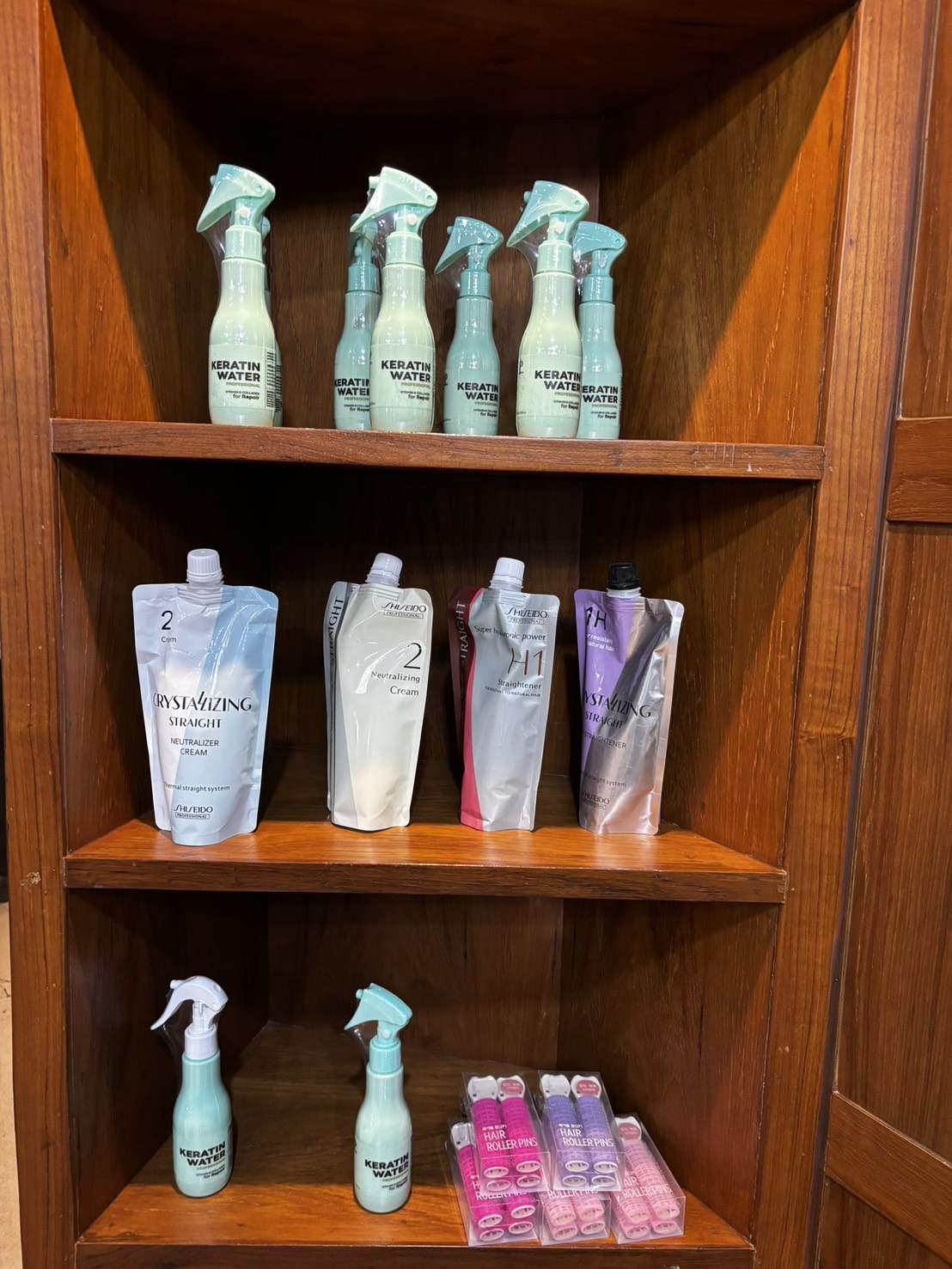 Shiseido Professional shelf — Keratin Water sprays above Crystallizing Straight straightener and neutraliser pouches